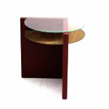 Mathieu Ficheroux (1926-2003)A red lacquered wooden occasional table with a copper and a circular