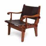 Angel PazminoA wooden easy chair with renewed brown leatherette seat and backrest, produced in