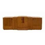 Art DecoAn impressive mahogany, burr and Loupe d'Amboine veneered sideboard with staggered
