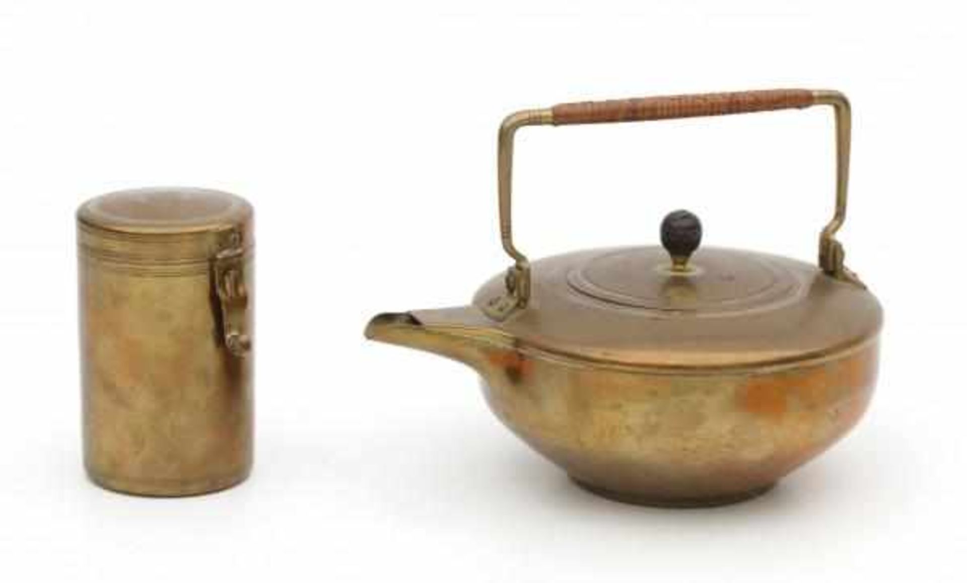 Jan Eisenloeffel (1876-1957)A brass teapot with cane wickered handle and wooden grip (loose),