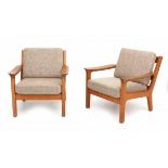 Midcentury ModernA pair of oak lounge chairs with amorphous shaped armrests, possibly Danish, the