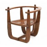 Amsterdamse SchoolAn oak easy chair, horseshoe-shaped, with cane wickered seat, 1920s.63 x 60 x 69