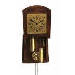 Willem Penaat (1875-1957)An oak wall clock with brass dial with repetitive geometrical corner