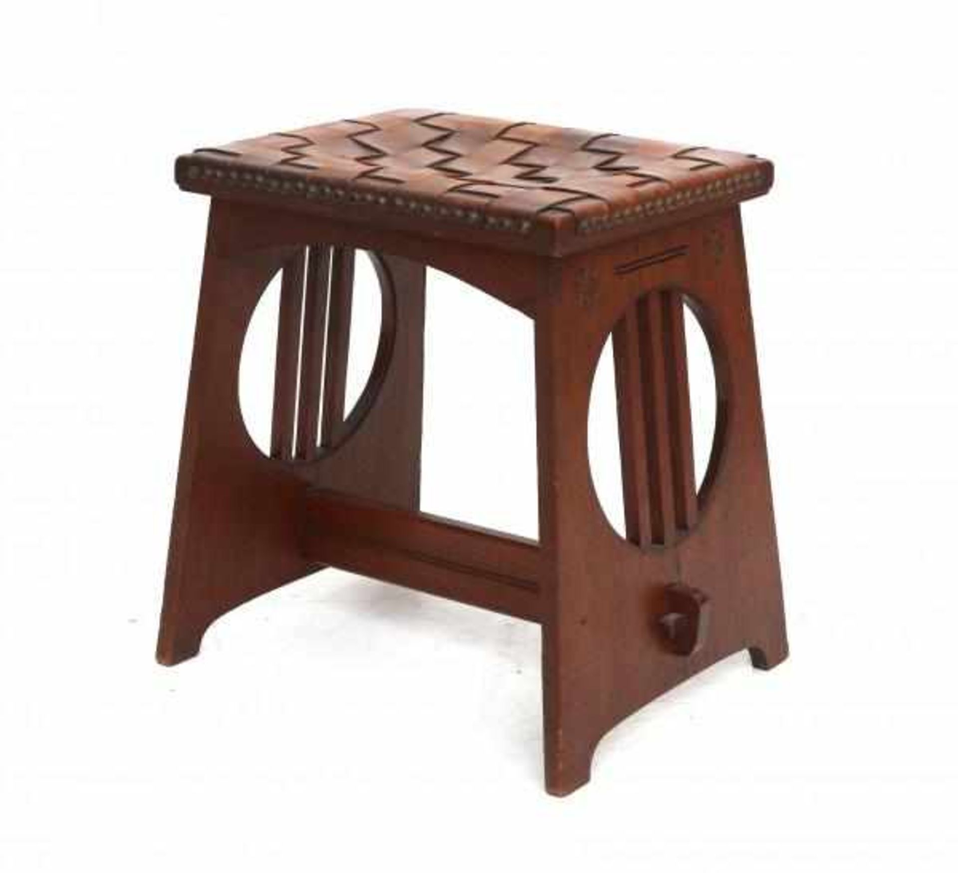 Arts & CraftsAn oak stool with carved ornaments of stylized flowers and a tressed seat with