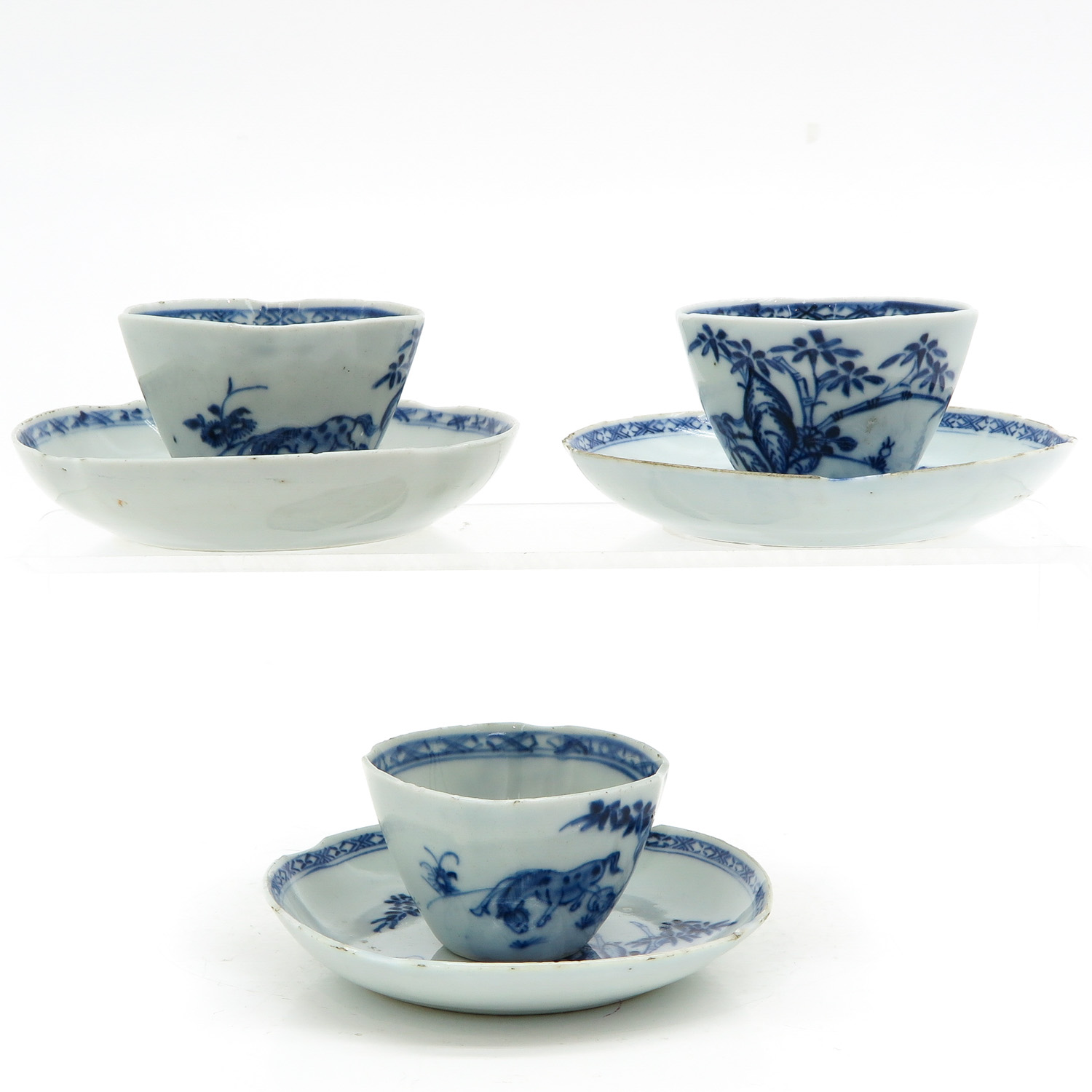 Three Blue and White Cups and Saucers