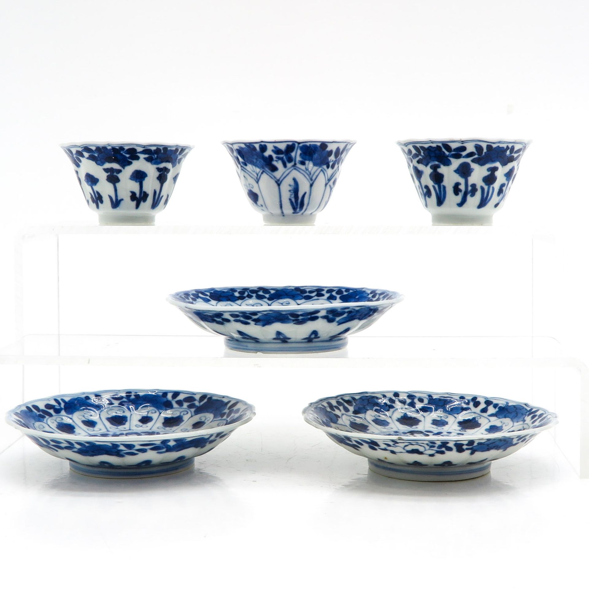 Three Blue and White Cups and Saucers