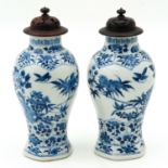 A Pair of Vases with Carved Wood Covers