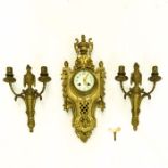 A Cartel Clock and Two Wall Sconces