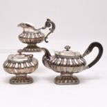 A Silver Tea Box, Creamer and Tea Can