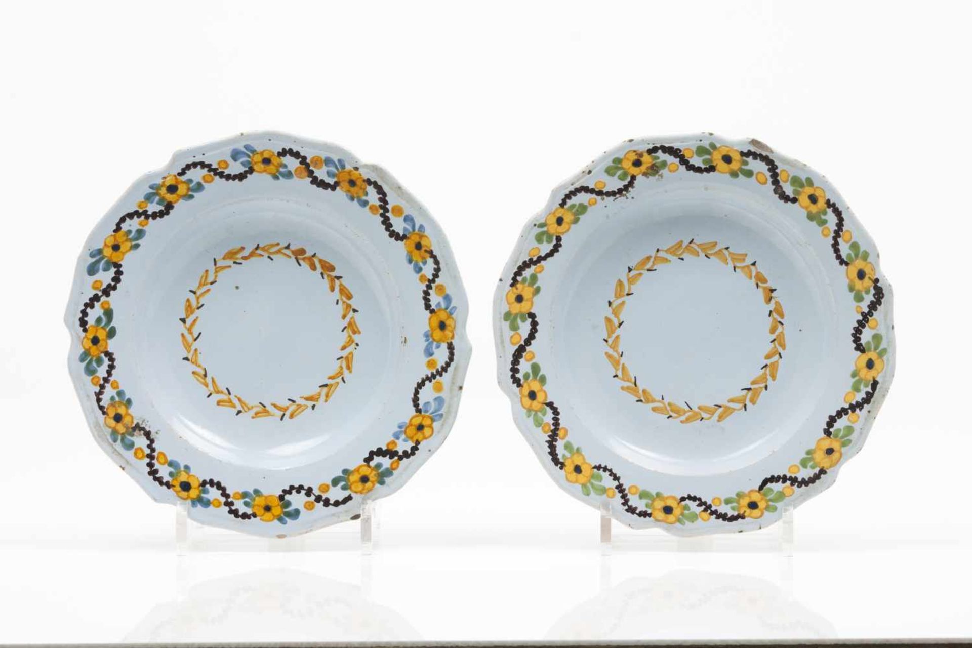 A pair of scalloped plates