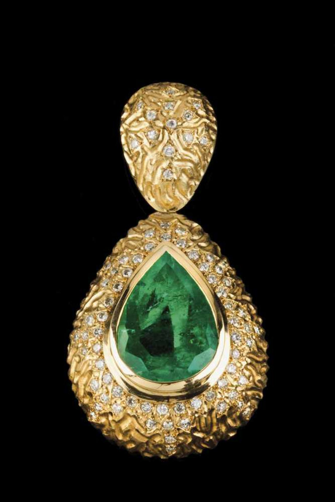 A large pendantGold of modernistic decoration set with and important pear cut emerald approx..