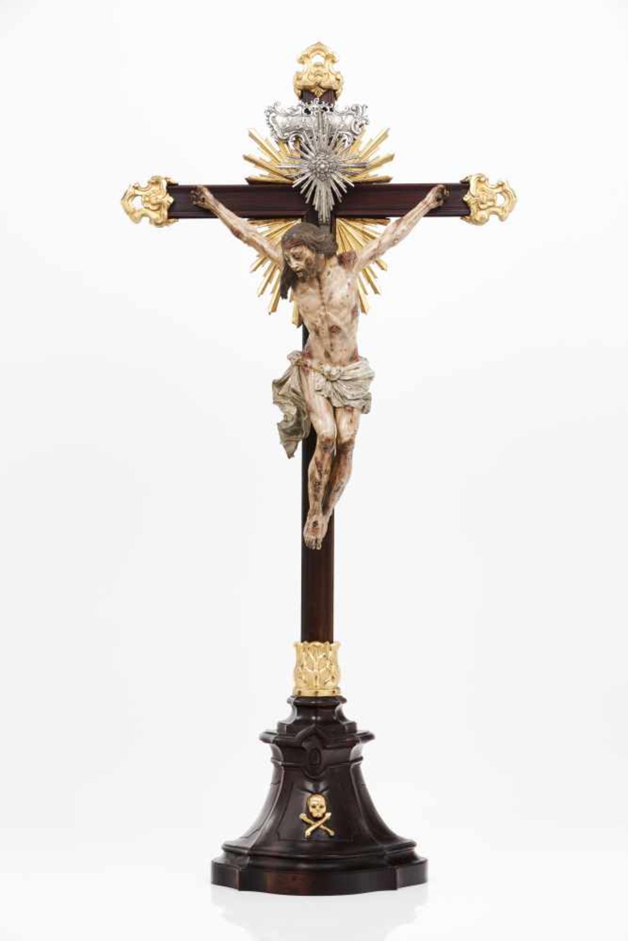 A crucified ChristCarved and polychrome sculptureRosewood cross and standSilver element