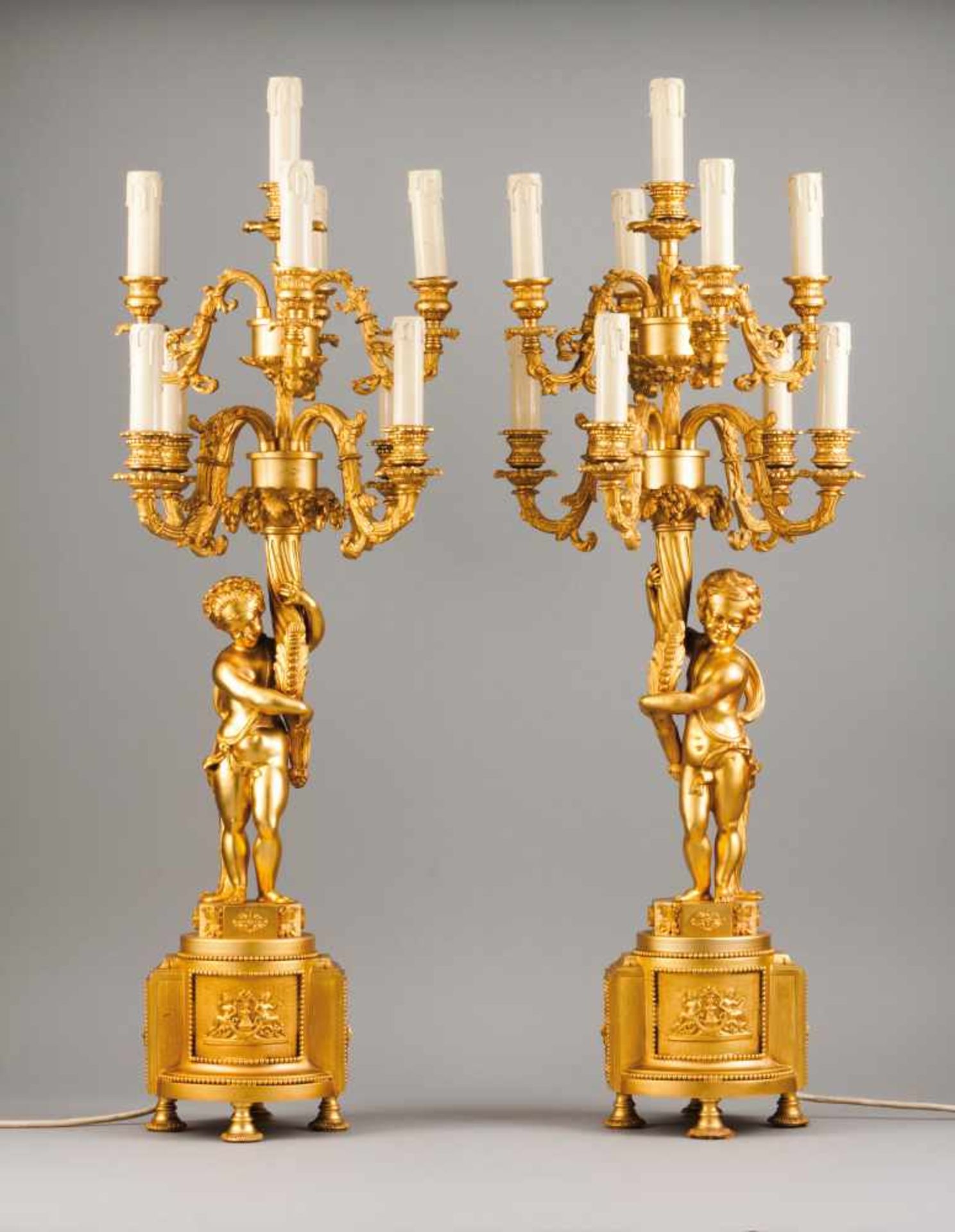 A pair of Louis XVI style nine light candelabra Gilt and relief bronze