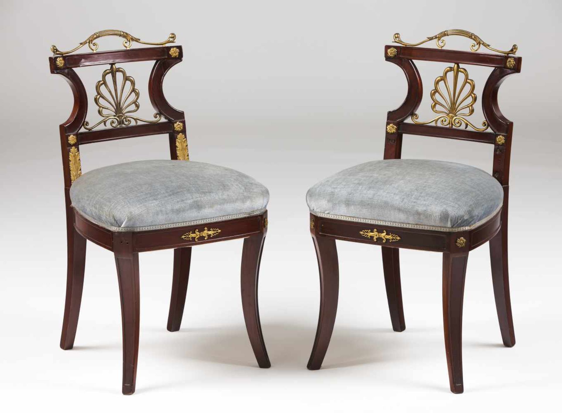 A pair of Empire style chairsMahoganyYellow metal applied elementsTextile upholstered s