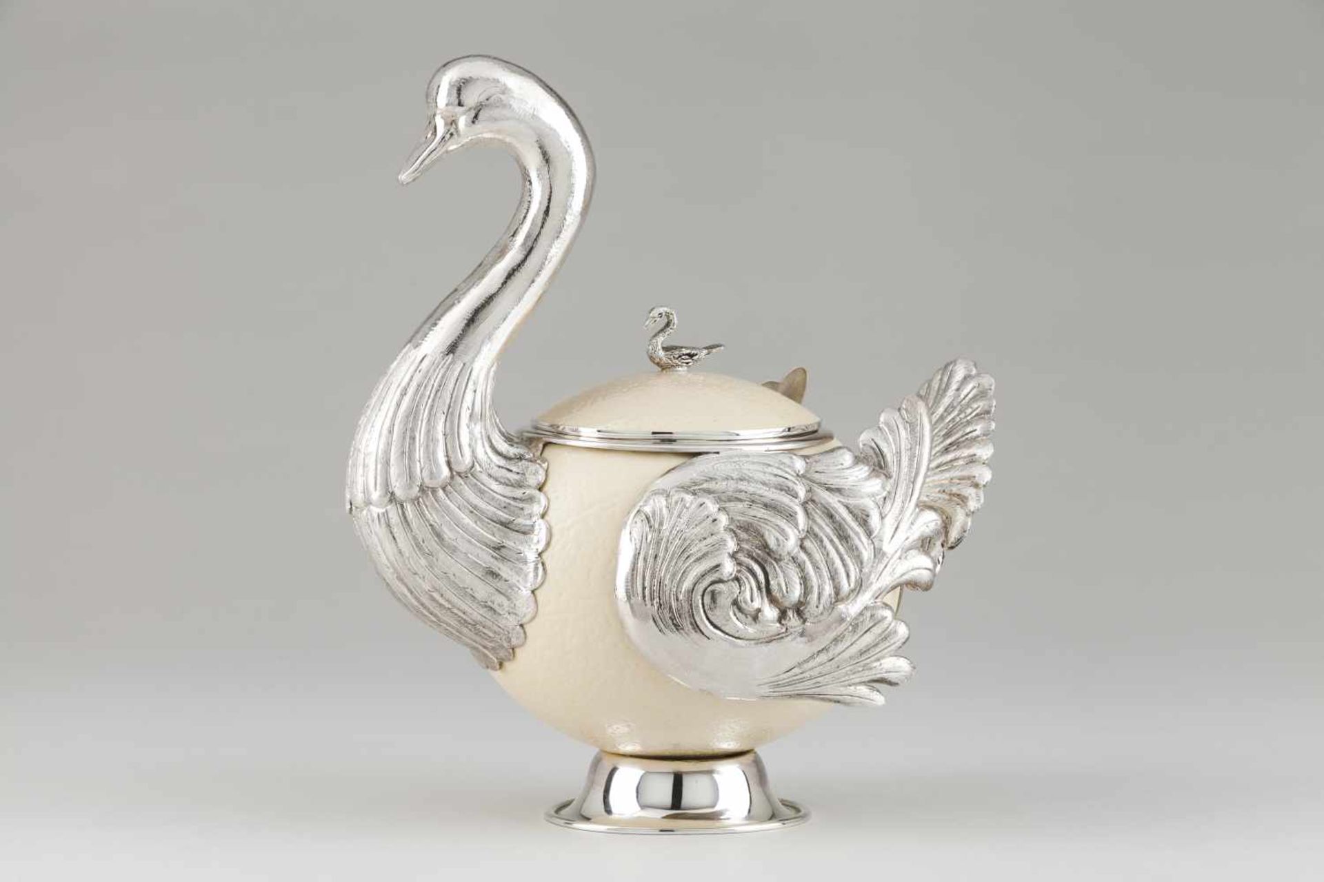 A duck boxRaised and chiselled silver and ostrich eggCarved duck sculpture lid pommelLi