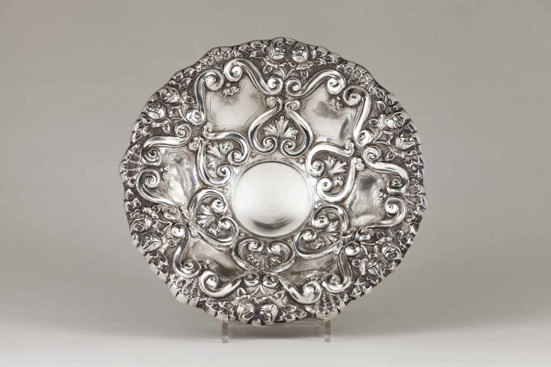 A fruit bowlPortuguese silverRepousse decoration of winglets, foliage and flowersOn a c