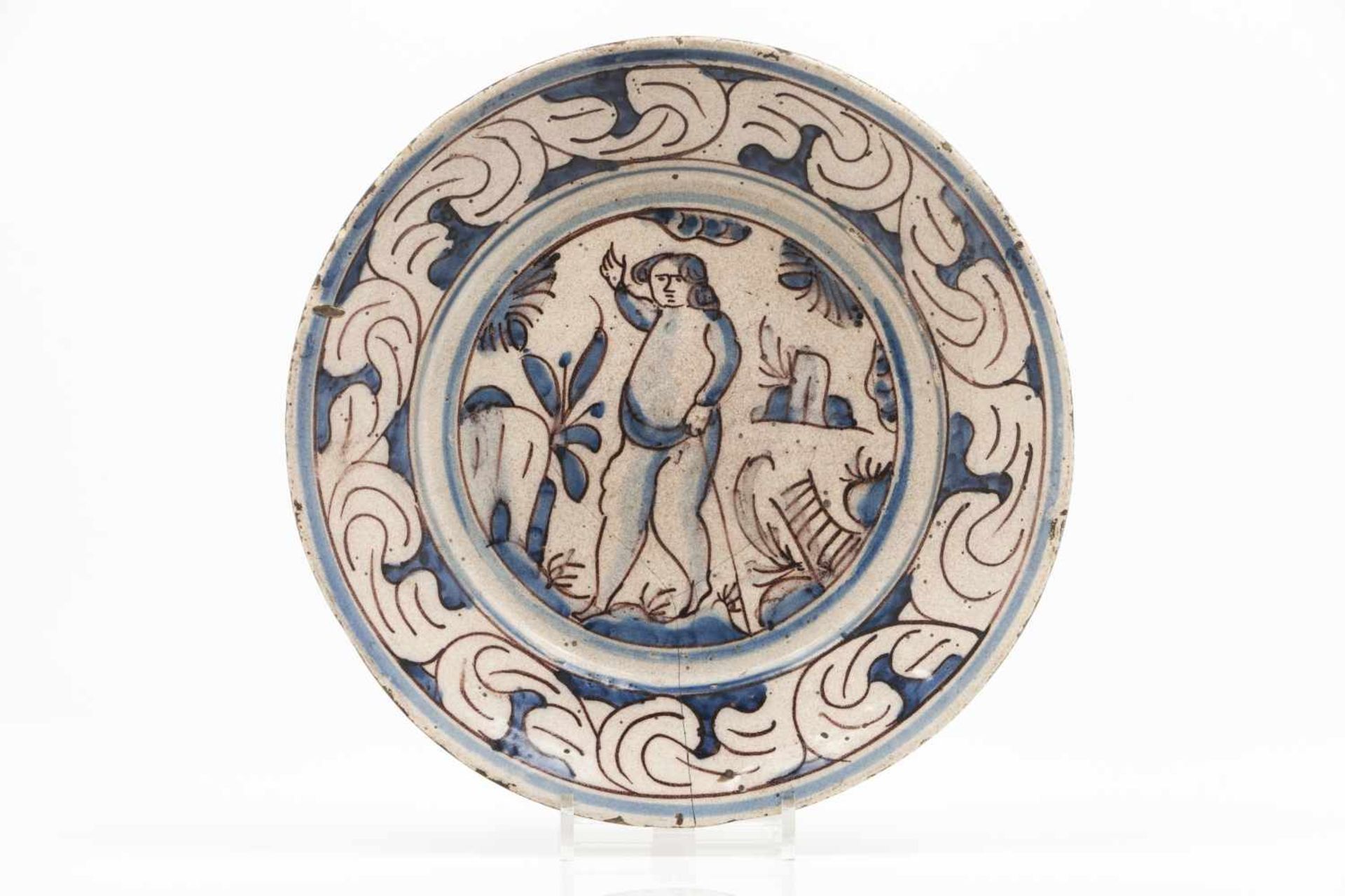 A platePortuguese faienceBlue and manganese decoration of central landscape with figure