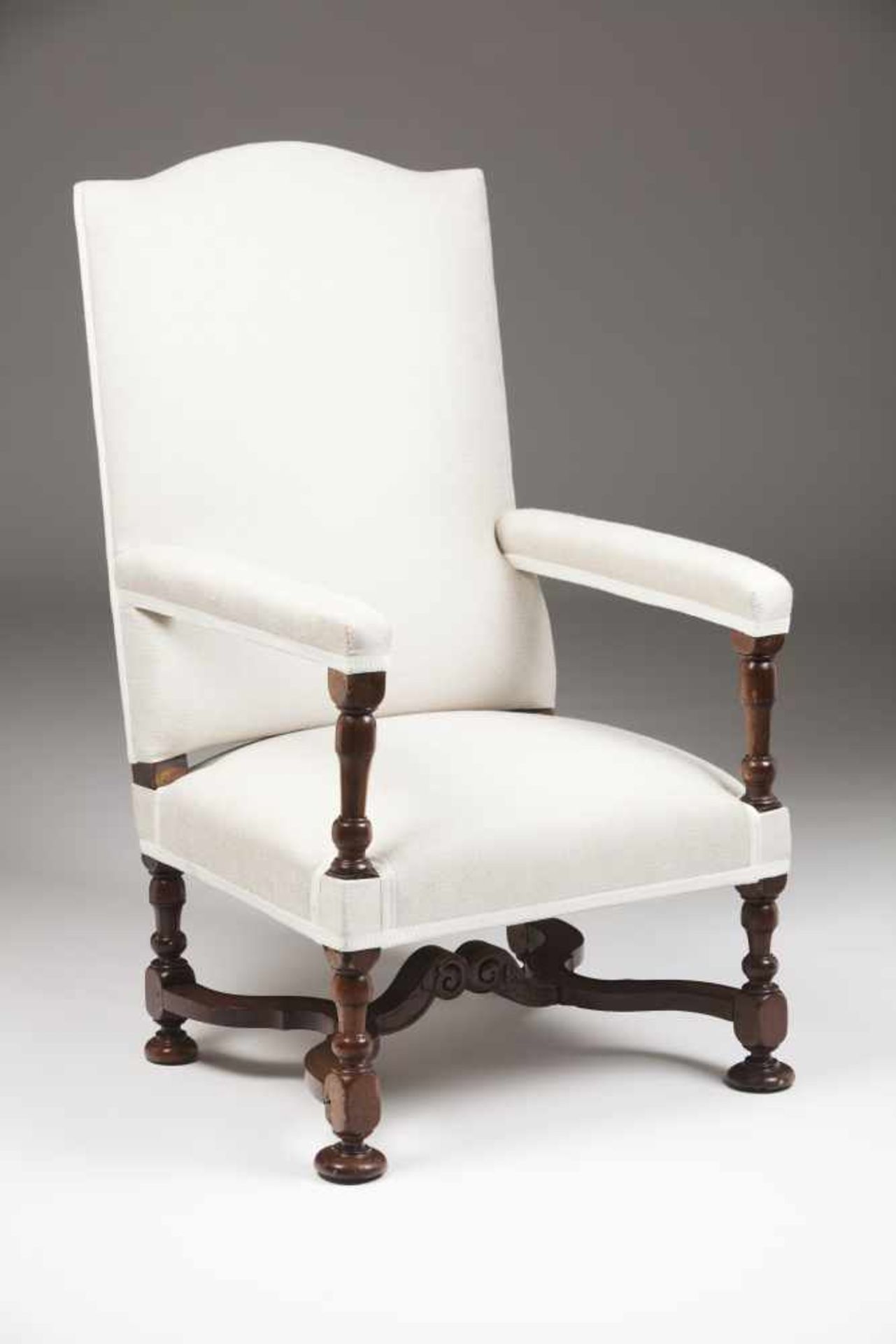 A Queen Anne library armchairWalnutTurned arms and legs, "X" shaped stretchersFabric up
