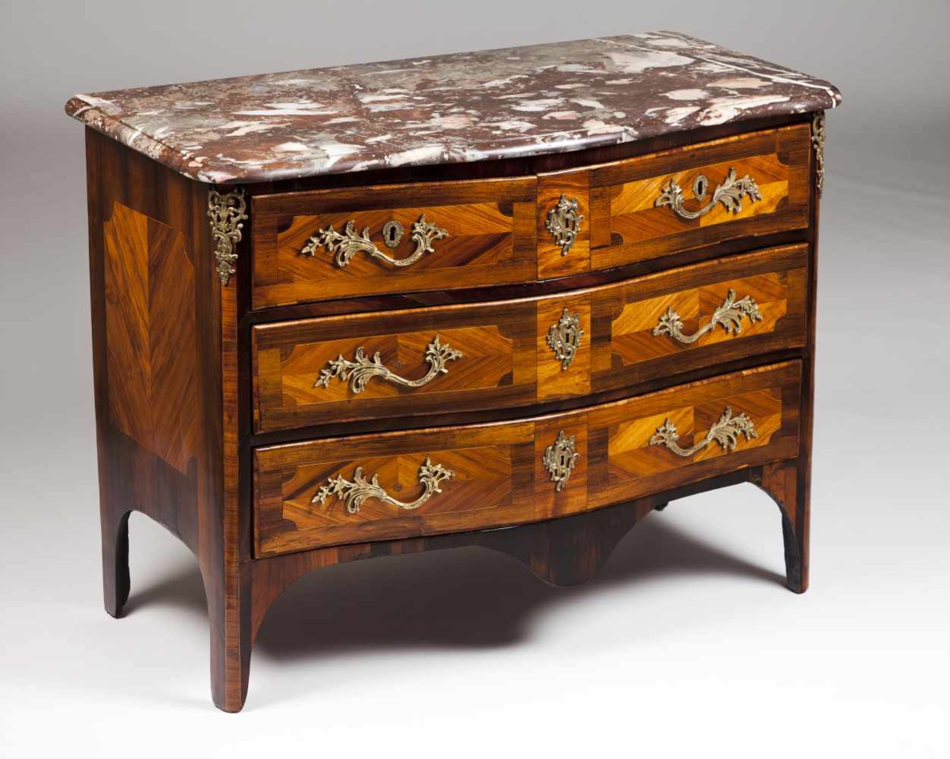 A Louis XV commodeJacaranda and rosewood veneer with marquetry decorationTwo short and two