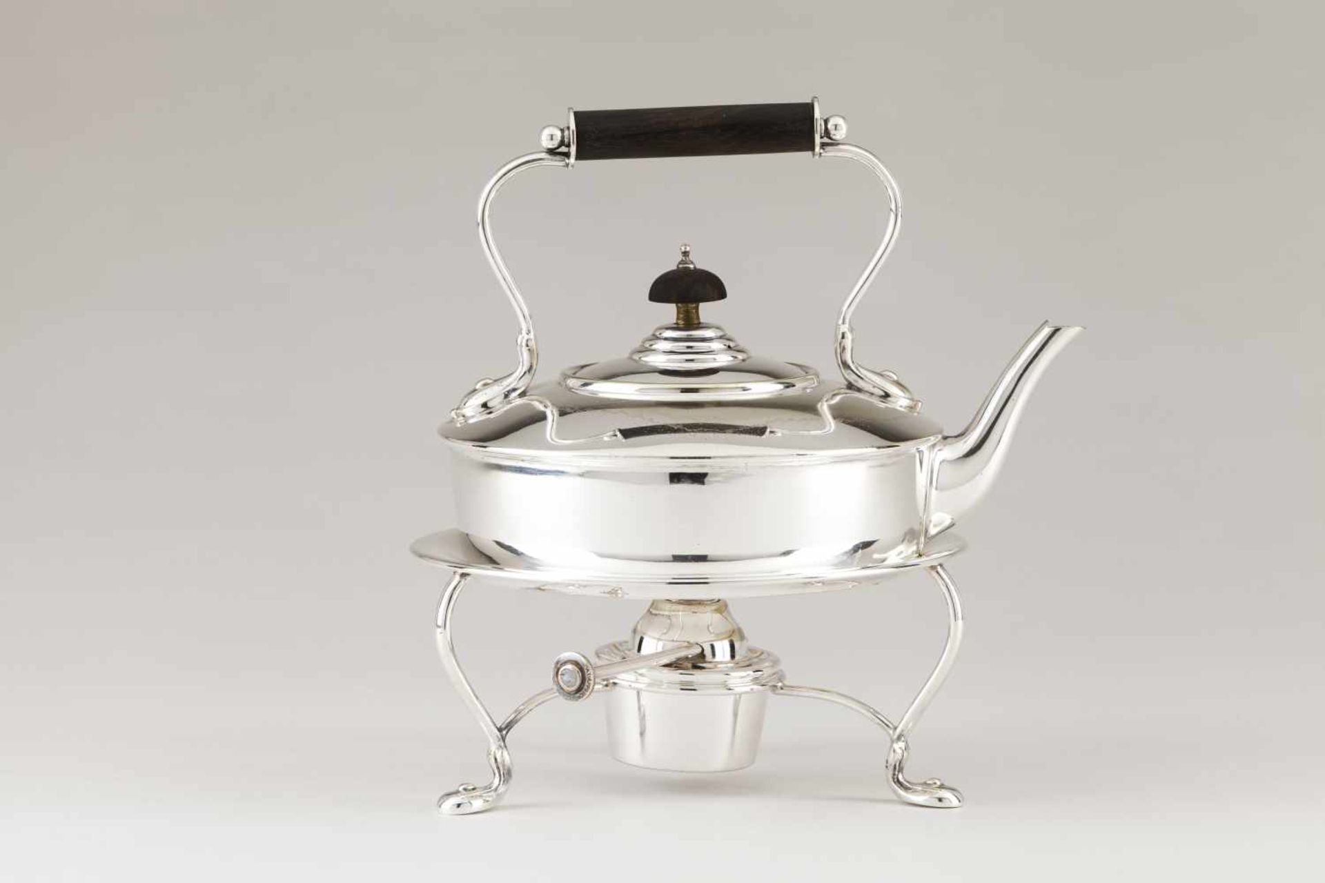 A kettle on stand with burnerSilvered metalPlain body of straight lines with wooden handle