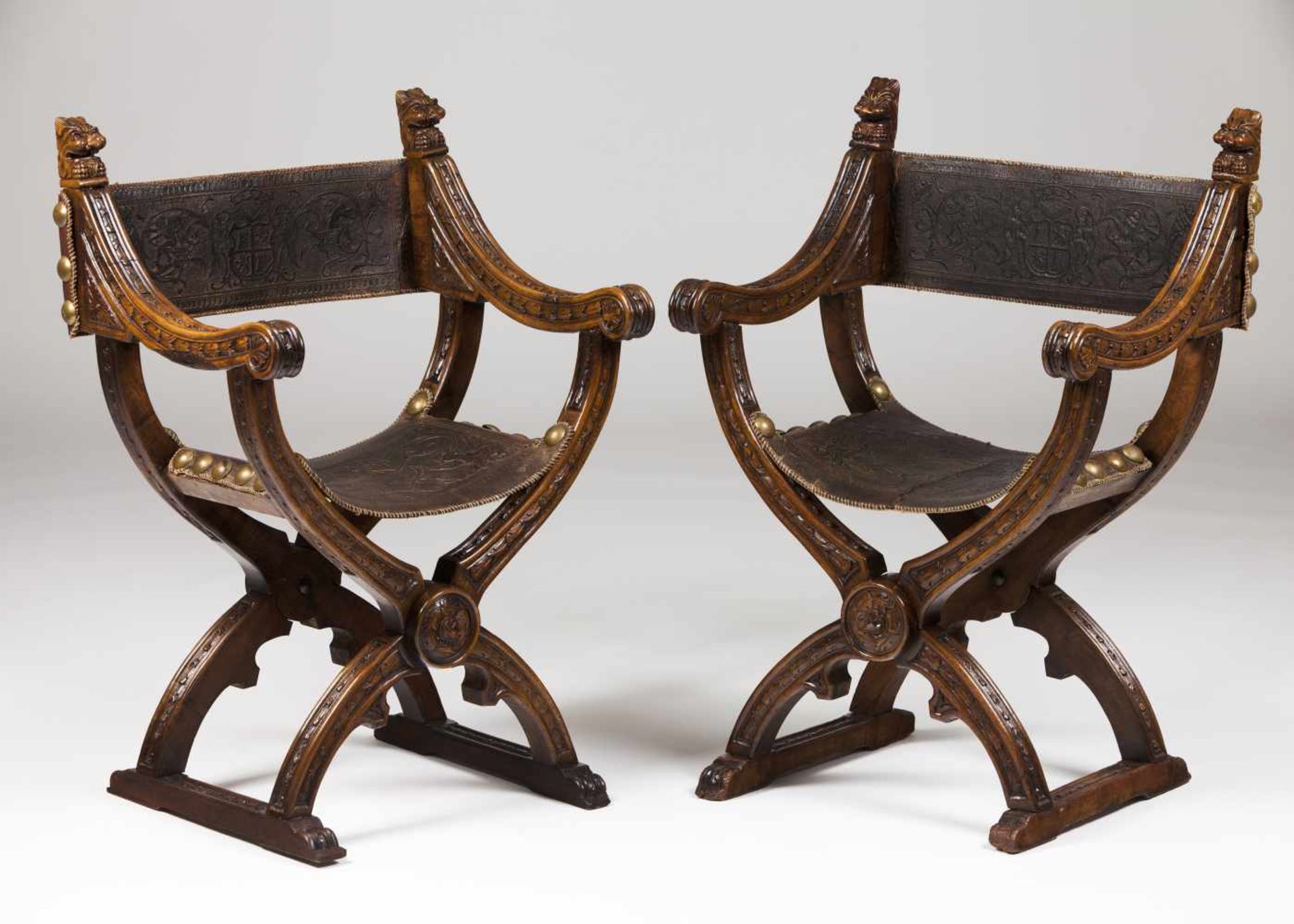 A pair of Savonarola chairsWalnutCarved floral and foliage motifs and classical mask decora