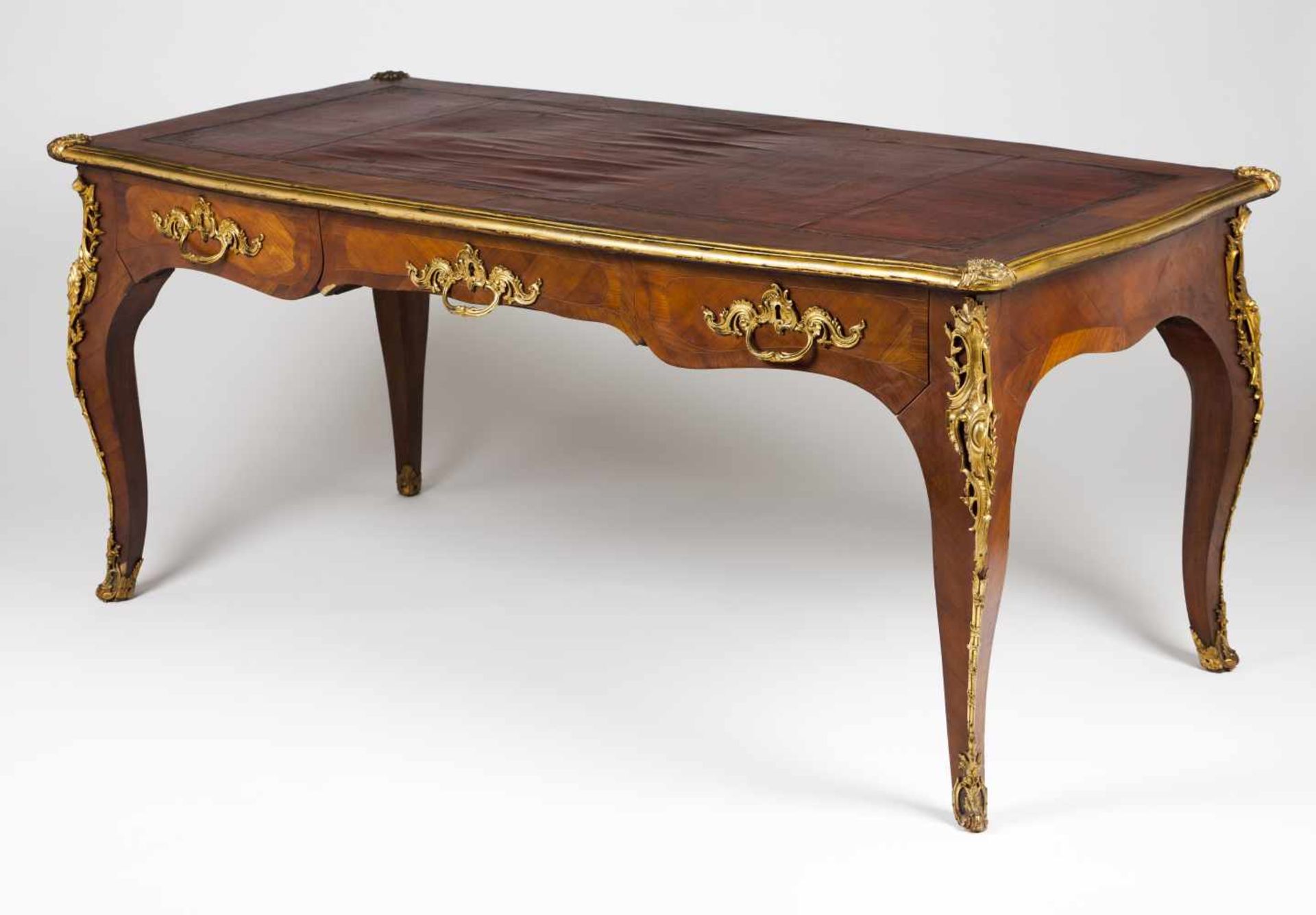 A Louis XV style writing deskCherrywood and other timbersLeather top and chiselled and gilt