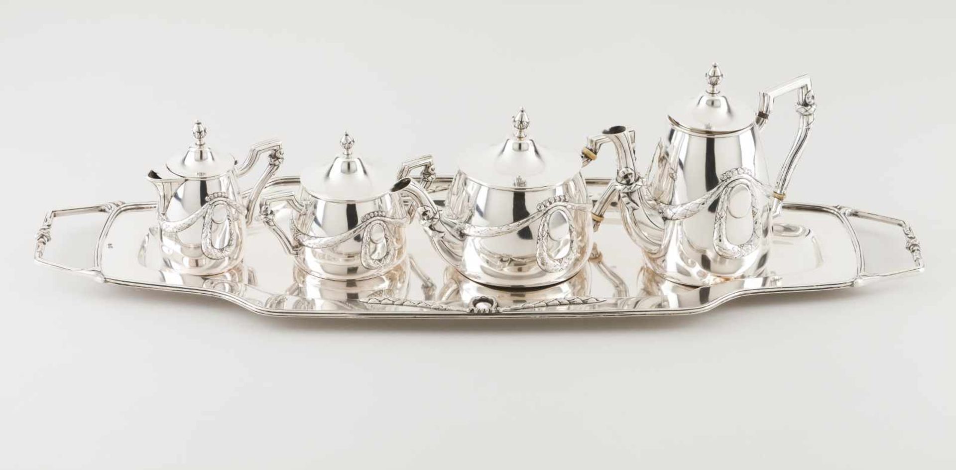 A tea and coffee set with trayPortuguese silverRomantic era decoration of bows, ribbons and