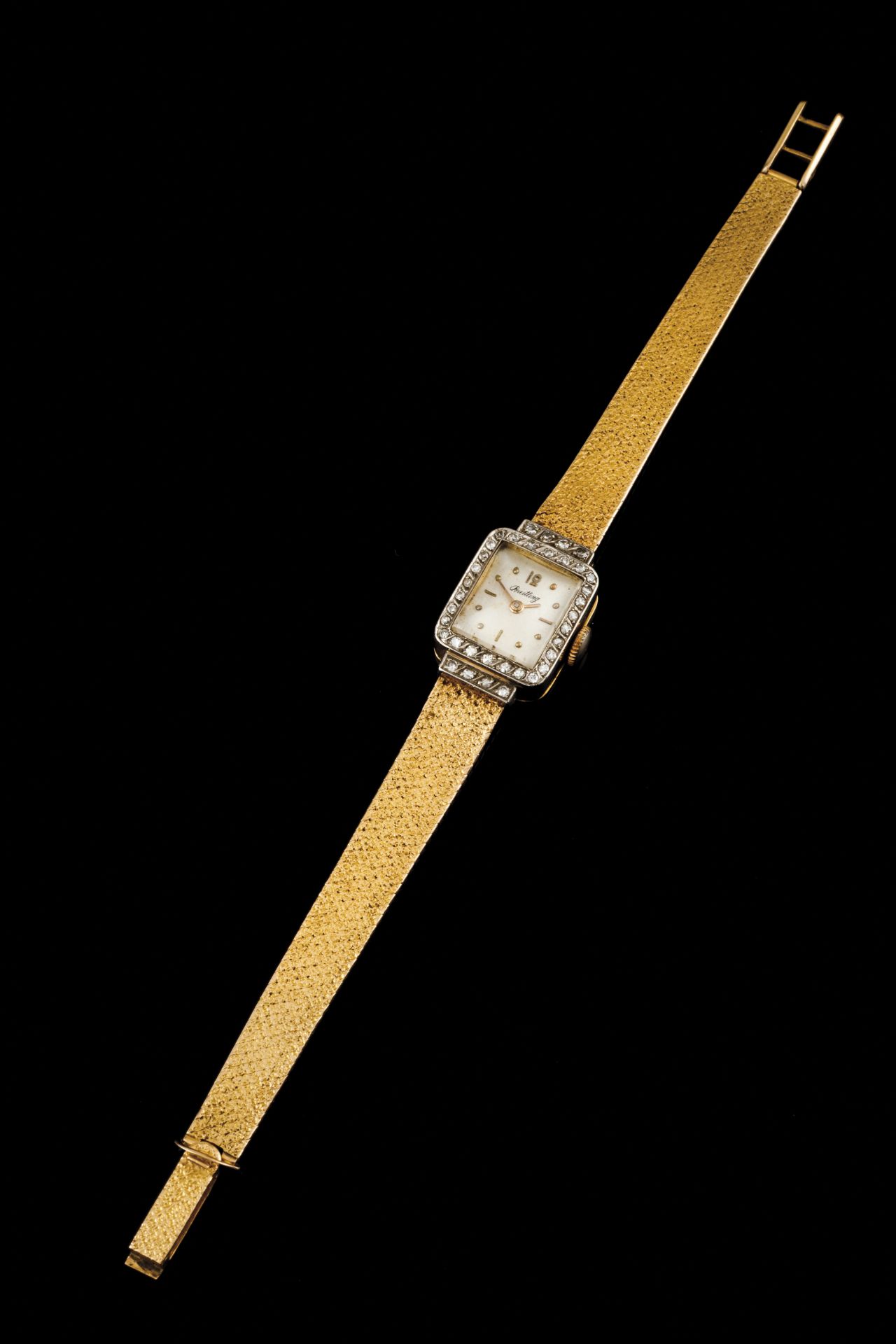 A BreitlingGoldLady's wrist watch of rectangular case and bevel set with 38 8/8 cut diamondsWhite