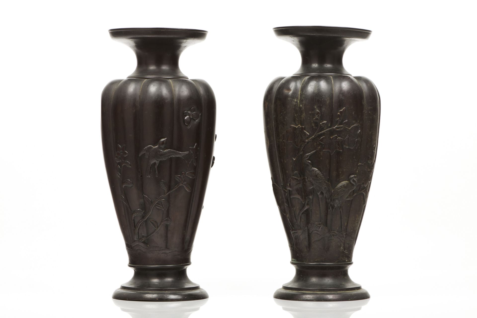A pair of vasesPatinated bronzeBaluster shaped, scalloped and of raised decoration depicting