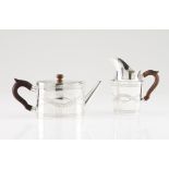 A D. Maria teapot and milkPortuguese silverChiselled oval body of floral and foliage bands, turned