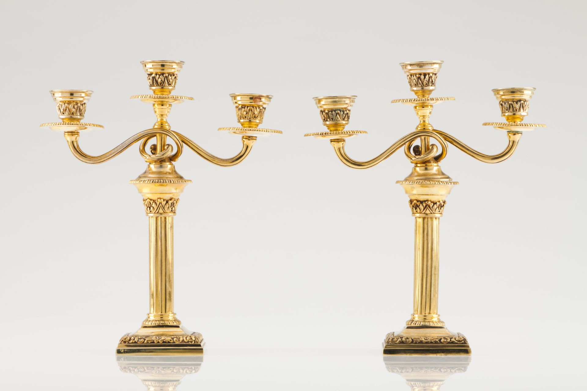 A pair of three branch candelabraPortuguese gilt silverDoric column shaft with foliage motif