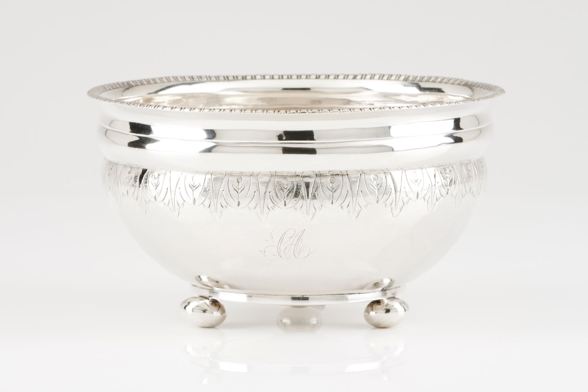 A drip bowlPortuguese silver, 19th centuryPlain turned body of engraved foliage band and gadrooned