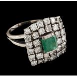 A ringGoldSet with one emerald cut emerald (ca.6x6mm) framed by 32 brilliant cut diamonds