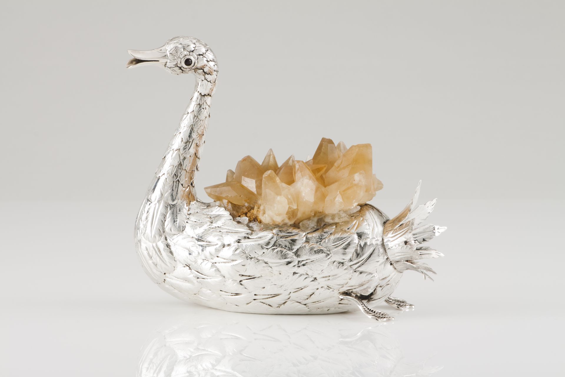A swanSilverMoulded and chiselled decoration with applied quartz crystalsArticulated neck and garnet