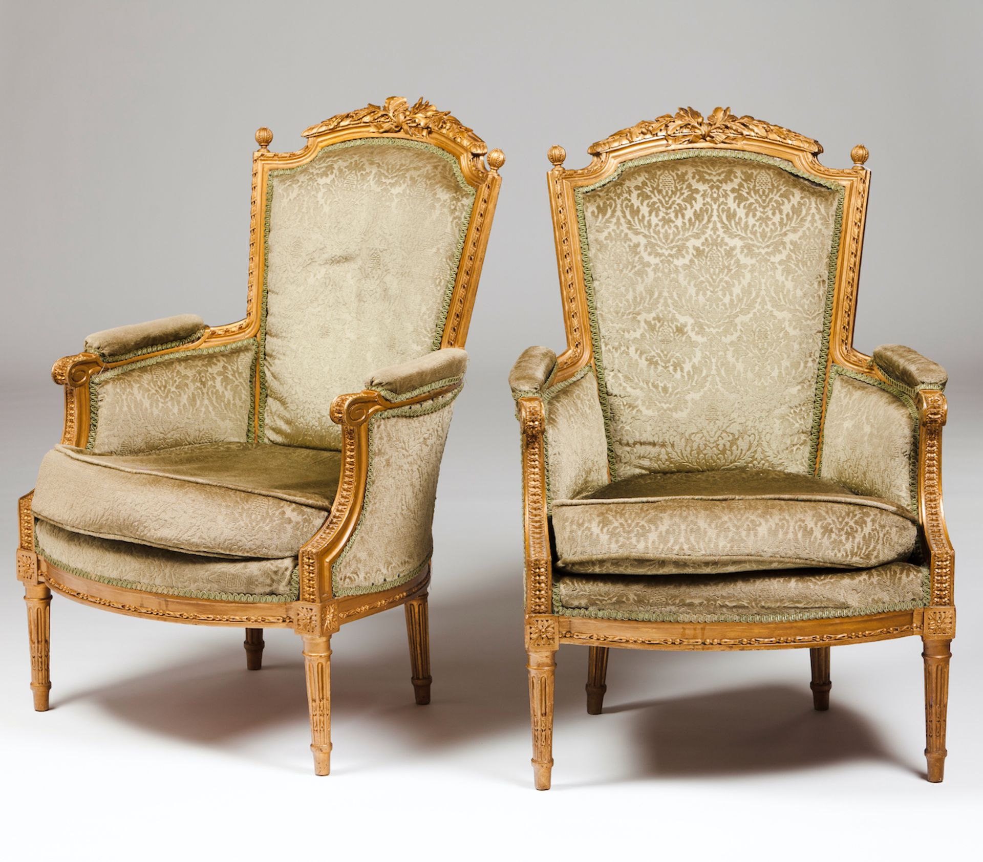 A pair of Louis XVI style bergèrescarved and gilt timberFabric lined seats, backs and armsFrance,
