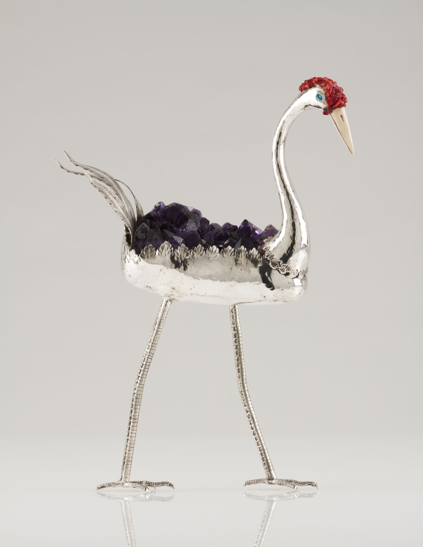 A long-legged birdSilver and amethyst crystalsMoulded, scalloped and chiselled sculptureRed dyed