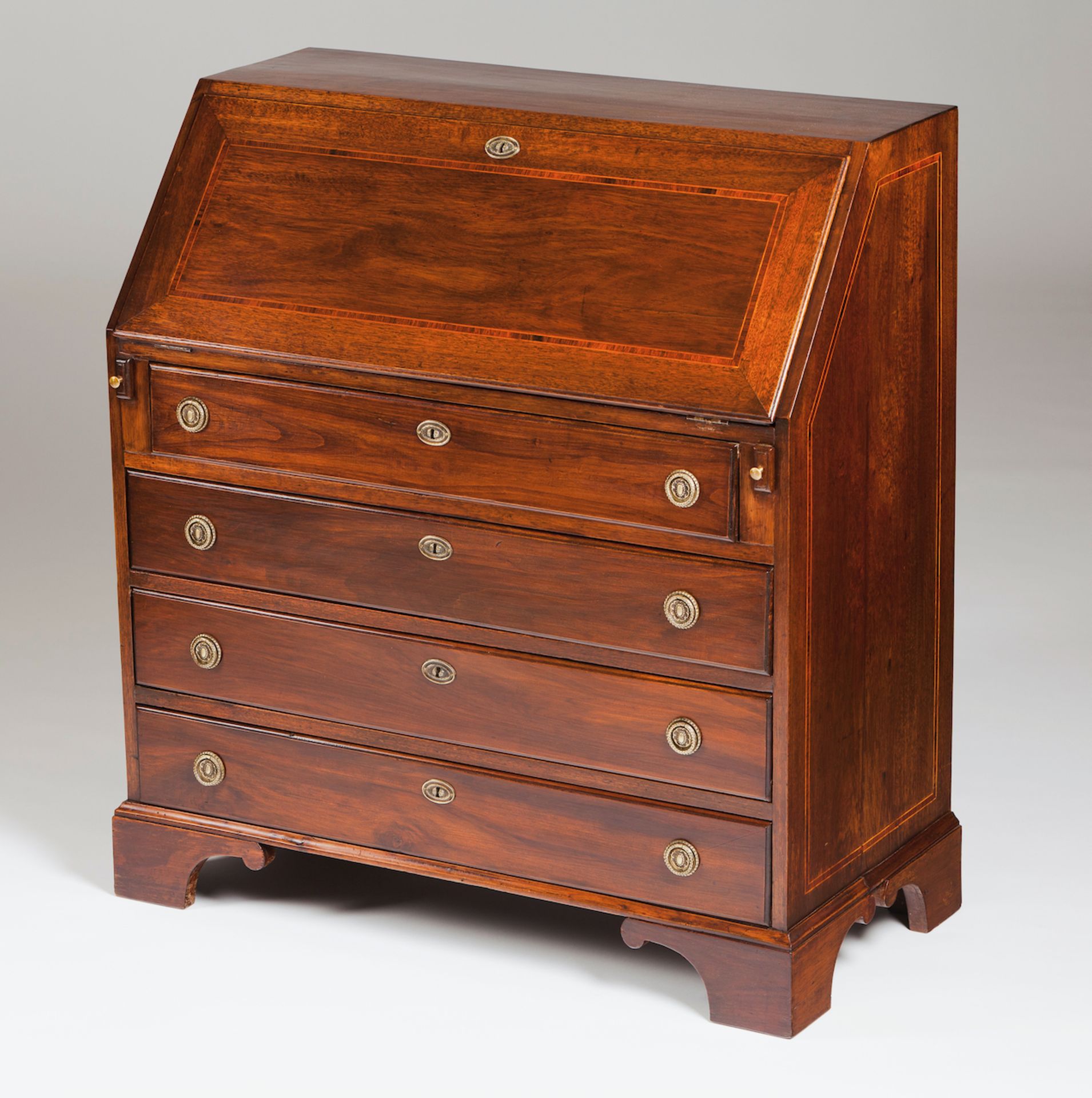 A George III bureauMahoganyInner drawers and pigeon-holesFour long drawersEngland, 19th century(wear