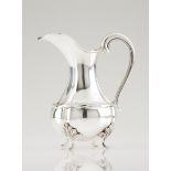 A ewerPortuguese silverTurned body of volute handle on 4 foliage decorated feetOporto hallmark,