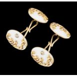 A pair of cufflinksGold 585/1000Oval shaped of white enamelled background and applied raised foliage