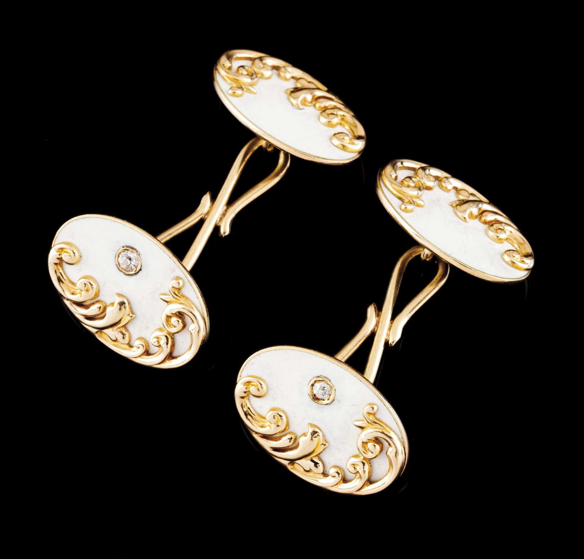 A pair of cufflinksGold 585/1000Oval shaped of white enamelled background and applied raised foliage