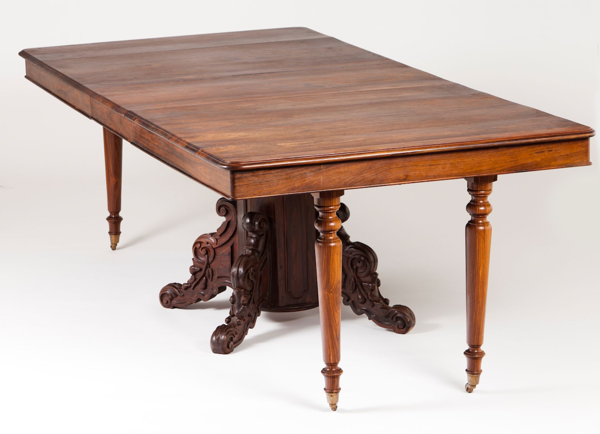 A large dining tableSolid and veneered rosewoodCentral stand of carved decorationExtra leg support