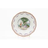 A scalloped soup plateChinese export porcelainPolychrome "Famille Rose" decoration of European