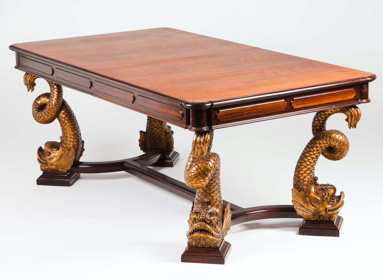 A dining tableSolid and veneered mahoganyDolphin carved and gilt decoration to legsFrance, 19th /