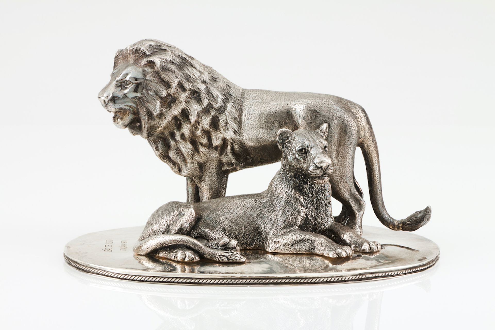A pair of lionsPortuguese silverSculpture depicting a Kizigo (Tanzania) lion and lioness on an