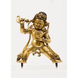 A gilt-bronze figure of VajrapaniDepicting a standing Vajrapani, with fierce face, third eye on