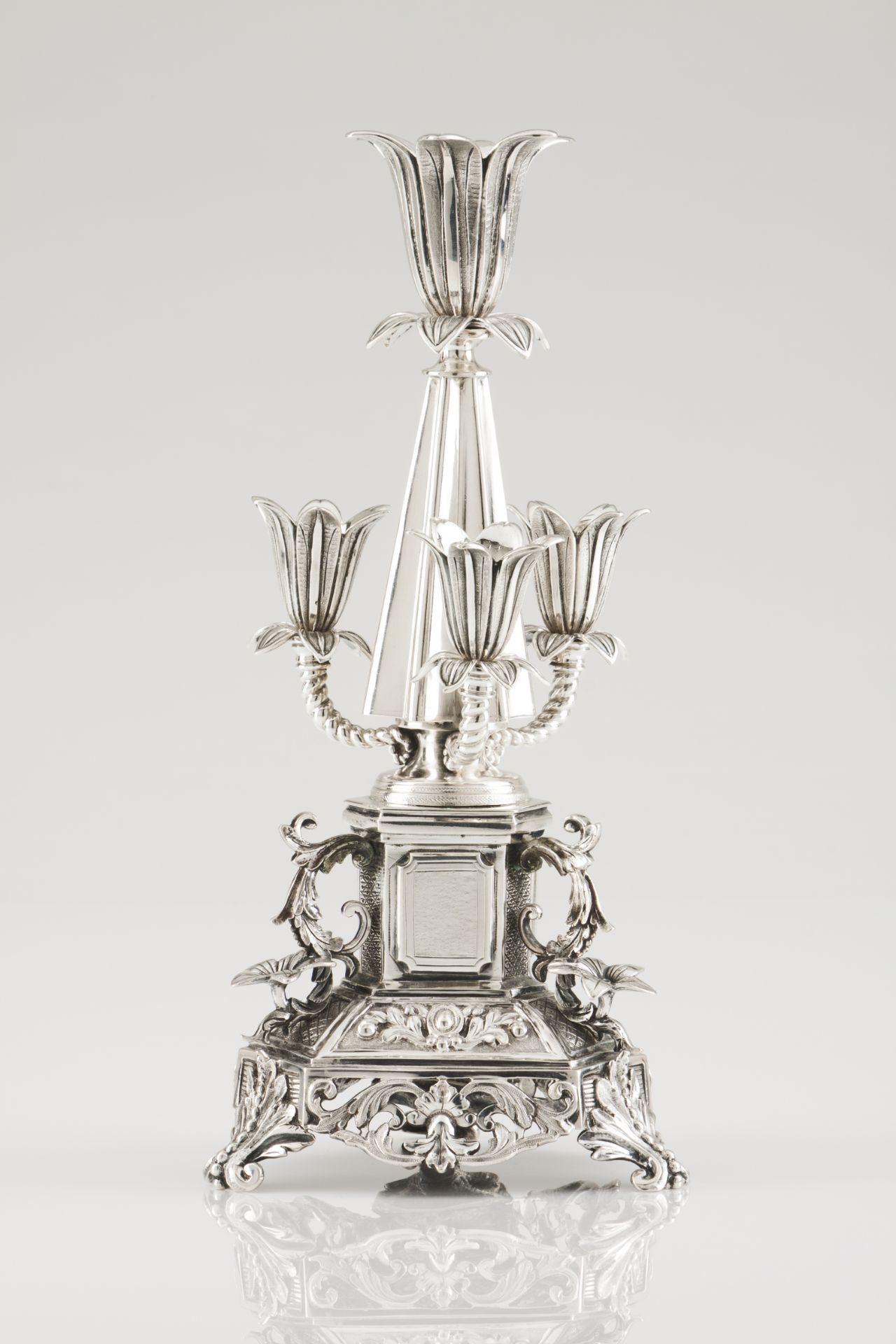 An unusual toothpick holderPortuguese silver, 19th centuryFour tulip pleated cone shaft on a