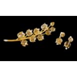 A brooch and earrings setGoldChiselled trunk with 10 applied tulip carved citrine quartz's' set with