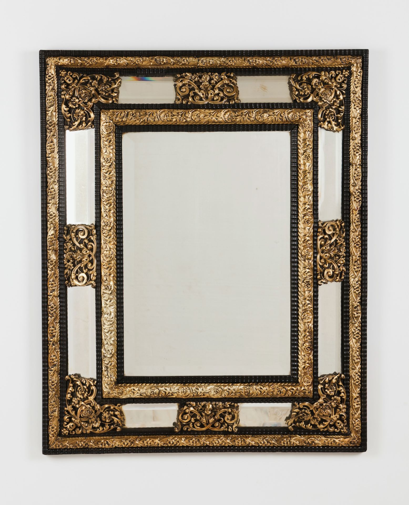 A wall mirrorCase frameRaised gilt metal decoration of floral and foliage motifsEurope, 19th