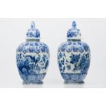 A pair of large pots with coversDelft faienceGadrooned body of blue floral and bird decorationLion