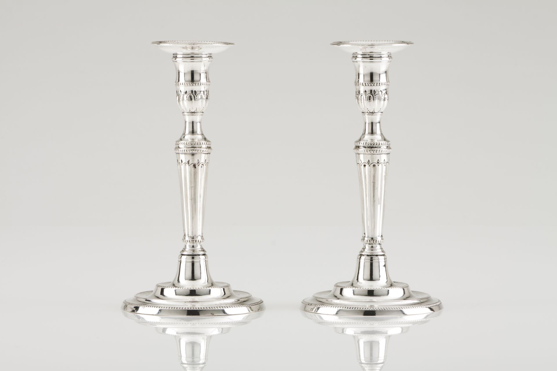 A pair of D. Maria candlesticksPortuguese silver, 18th / 19th centuryFluted shaft engraved with